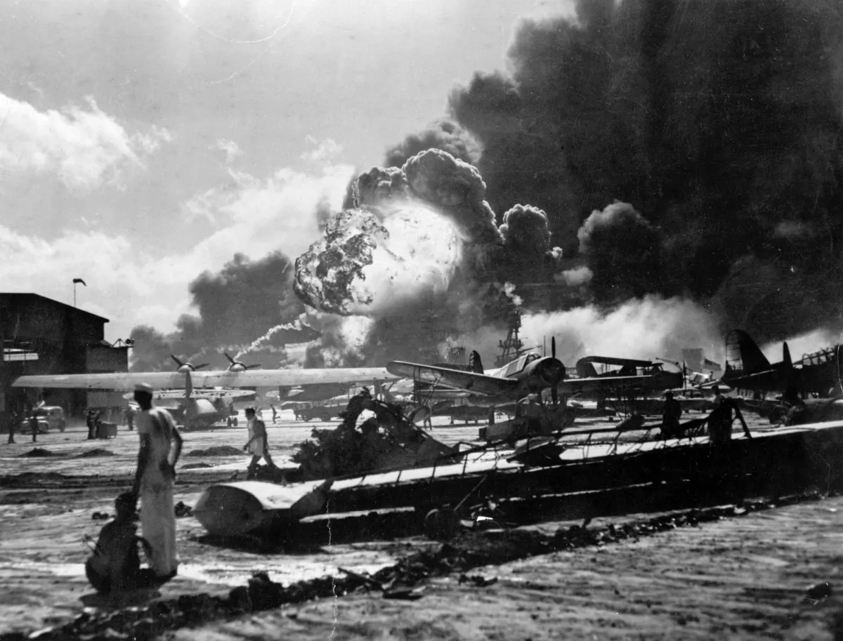 U.S. Sailors stand amid wreckage watching as the USS Shaw explodes on Ford Island, Pearl Harbor, Hawaii, during the Japanese attack on Dec. 7, 1941. (Getty Images)