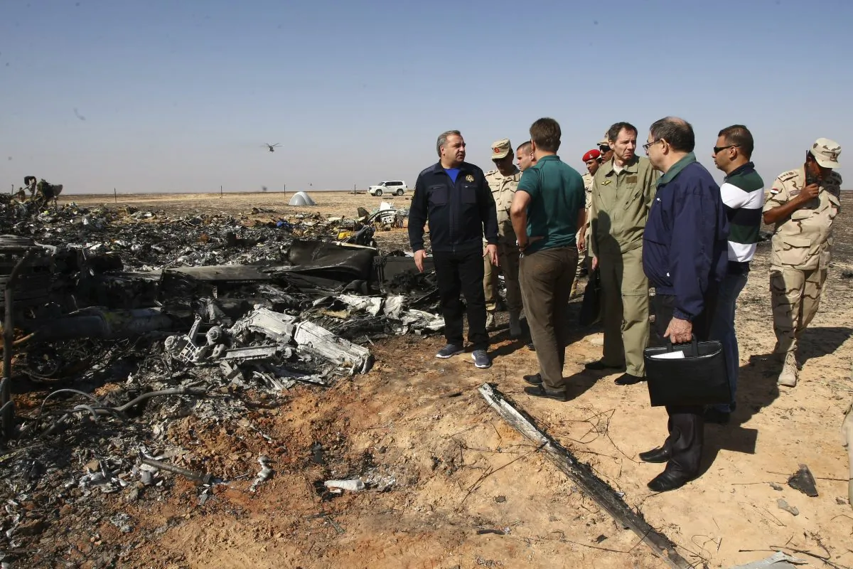 Russian Emergency Situations Minister Vladimir Puchkov (L) talks with Russian Transport Minister Maxim Sokolov (5R), as they inspect the wreckage in Hassana, Egypt, on Nov. 1. (Maxim Grigoriev/Russian Ministry for Emergency Situations via AP)