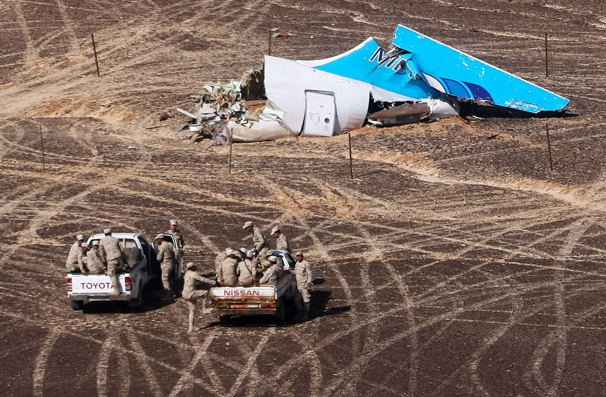 Egyptian Military on cars approach a plane's tail at the wreckage of a passenger jet bound for St. Petersburg in Russia that crashed in Hassana, Egypt, on Sunday, Nov. 1, 2015. (Maxim Grigoriev/Russian Ministry for Emergency Situations via AP)