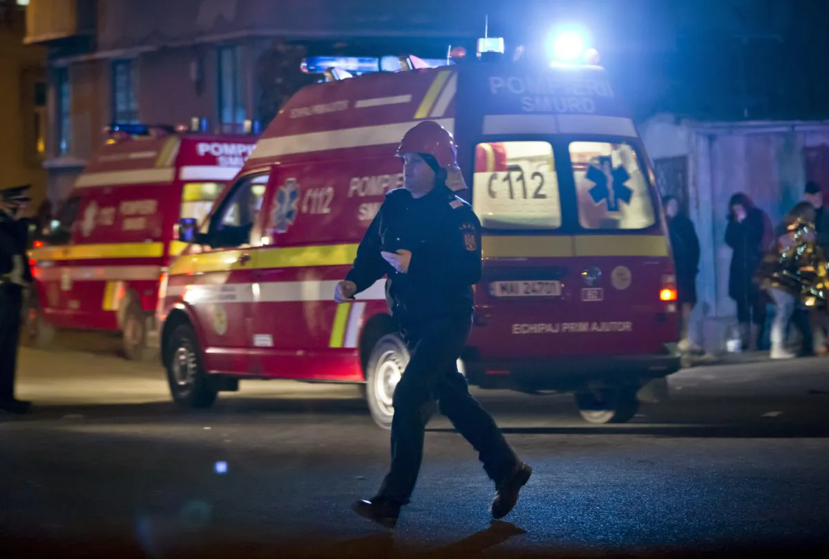 A firefighter runs at the site of a fire that occurred in a club in Bucharest, Romania, early Saturday, Oct. 31, 2015. (AP Photo/Vadim Ghirda)