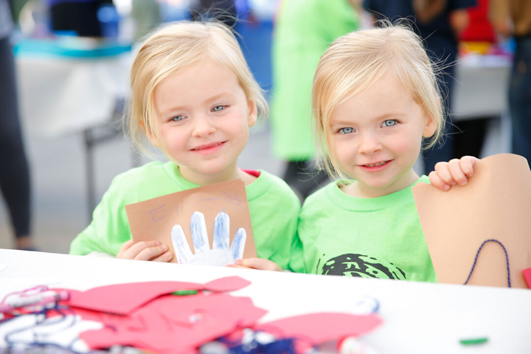 Mia and Ella Allan make crafts for seniors and local childrens hospitals while generationOn and Hasbro Distribute Holiday Gifts to Local LA Families at El Centro del Pueblo on December 6, 2014 in Los Angeles, California. (Joe Scarnici/Getty Images for generationOn and Hasbro)