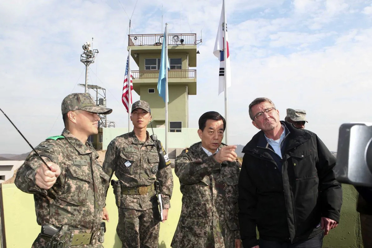 U.S. Defense Secretary Ash Carter, right, and South Korean Defense Minister Han Min Koo, second from right, look towards North Korea at an observation post near the border village of Panmunjom, which has separated the two Koreas since the Korean War, in Paju, South Korea, Sunday, Nov. 1, 2015. (Korea Pool Photo via AP)