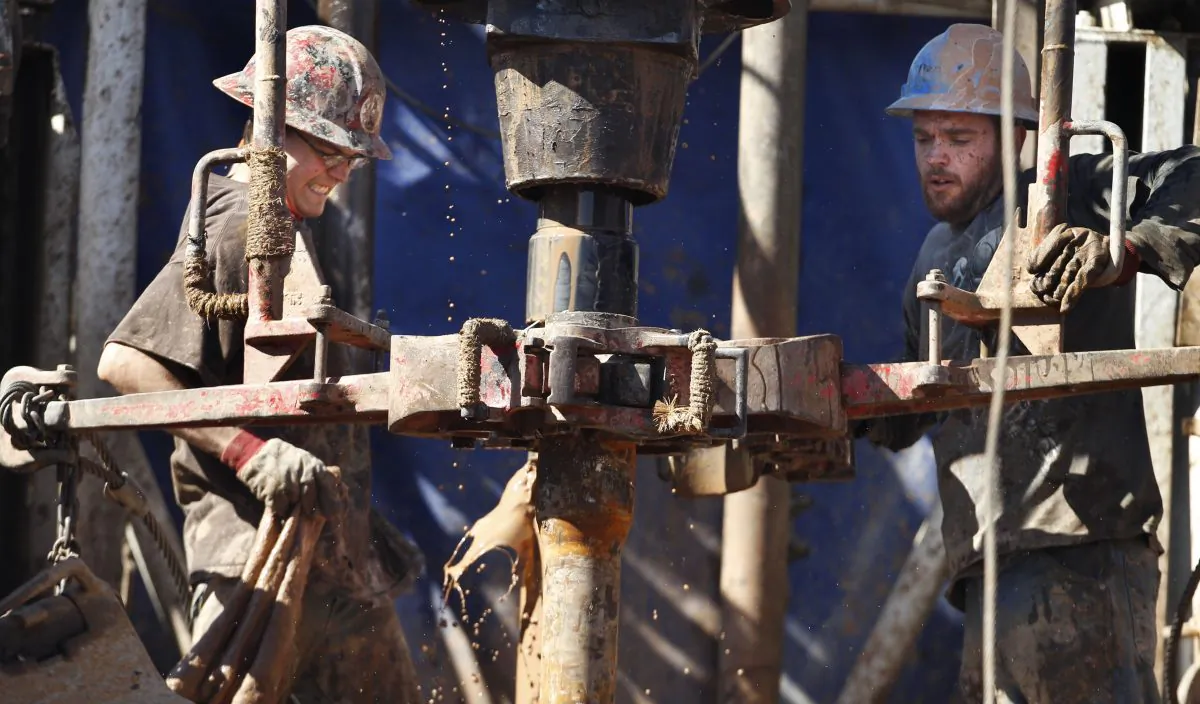 Oilfield workers drill into the Gypsum Hills near Medicine Lodge, Kansas on Feb. 21, 2012. (AP Photo/Orlin Wagner, File)