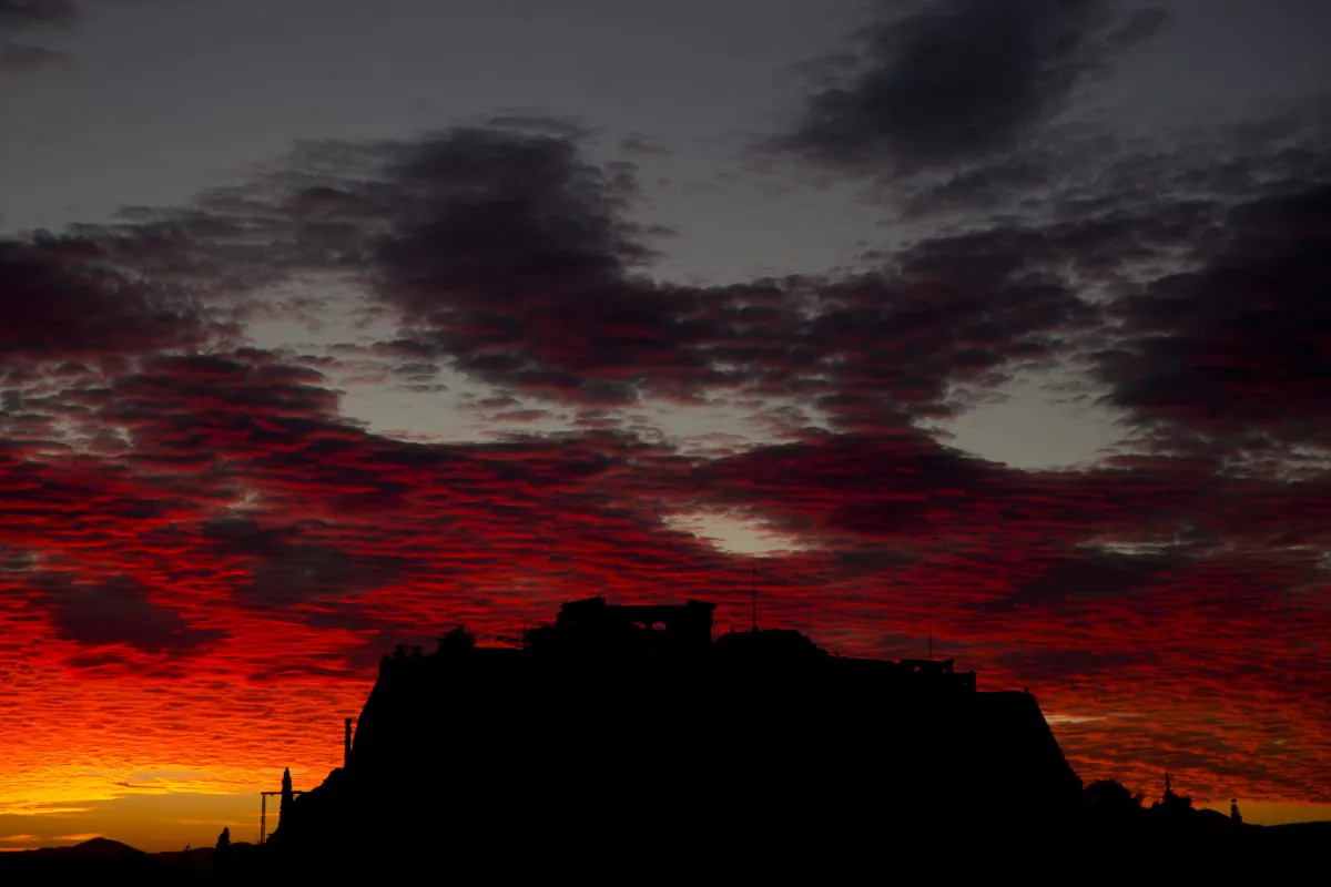 Red clouds are seen over the ancient Acropolis hill as the sun sets in the city of Athens, Tuesday, Nov. 3, 2015. (AP Photo/Petros Giannakouris)