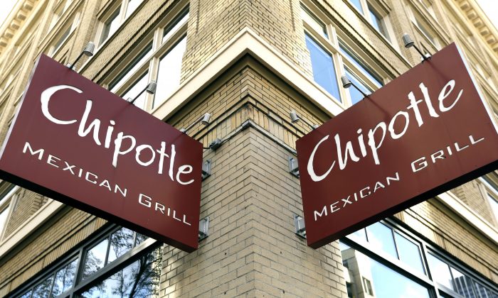 Signage hangs from a closed Chipotle restaurant in Portland, Ore., Monday, Nov. 2, 2015. (AP Photo/Don Ryan)