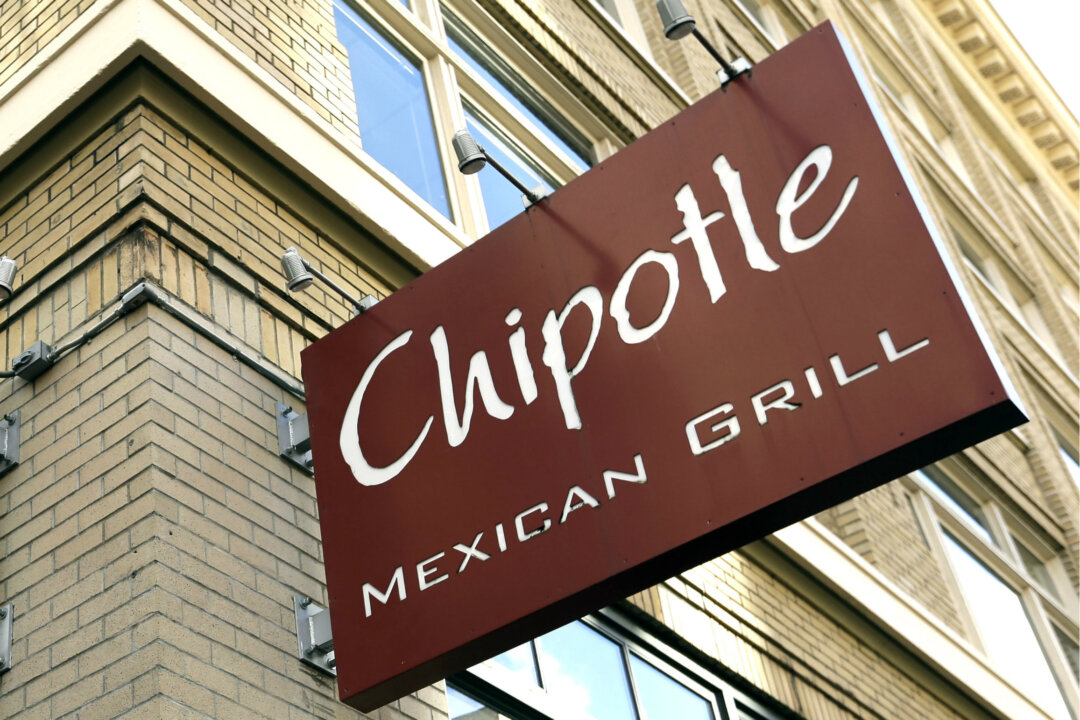 Signage hangs from a closed Chipotle restaurant in Portland, Ore., Monday, Nov. 2, 2015. (AP Photo/Don Ryan)