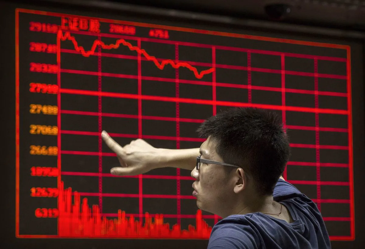 A Chinese day trader reacts as he watches a stock ticker at a local brokerage house on August 27, 2015 in Beijing, China. (Kevin Frayer/Getty Images)