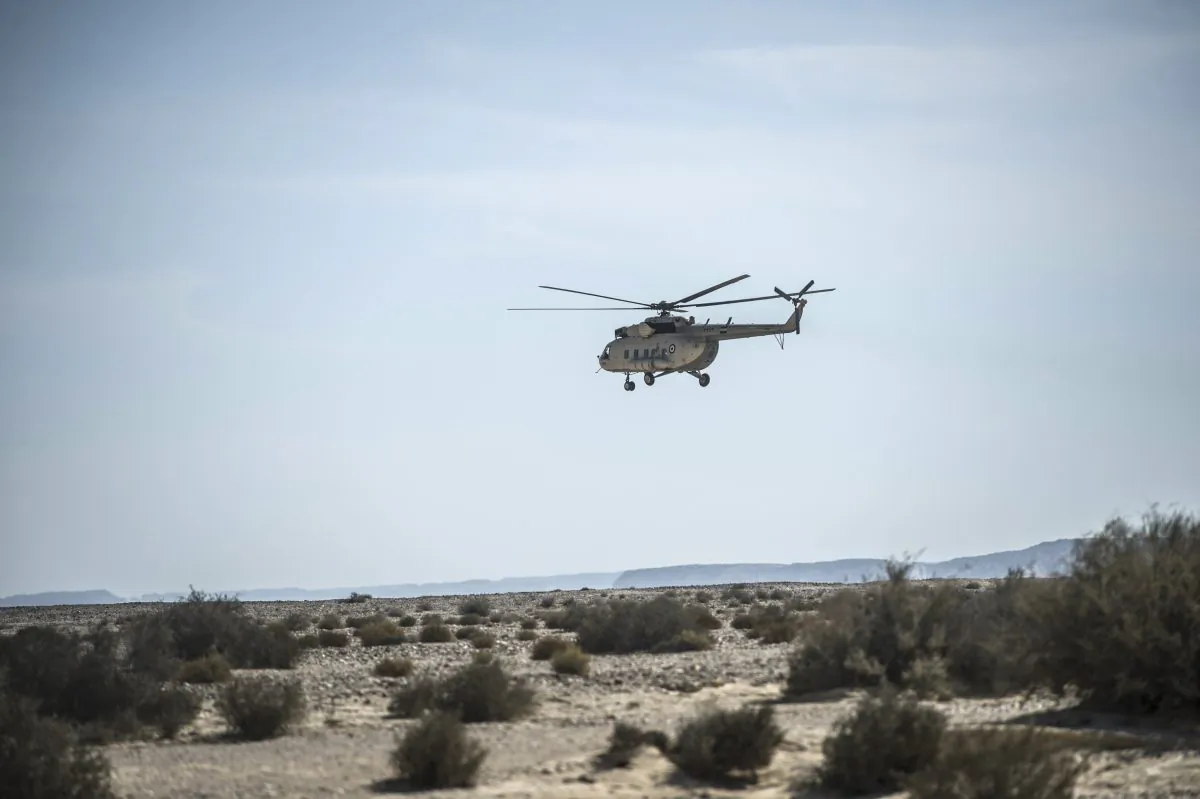 An Egyptian army helicopter flies over the crash site of an A321 Russian airliner in Wadi al-Zolomat, a mountainous area in Egypt's Sinai Peninsula, on Nov. 1, 2015. (Khaled Desouki/AFP/Getty Images)