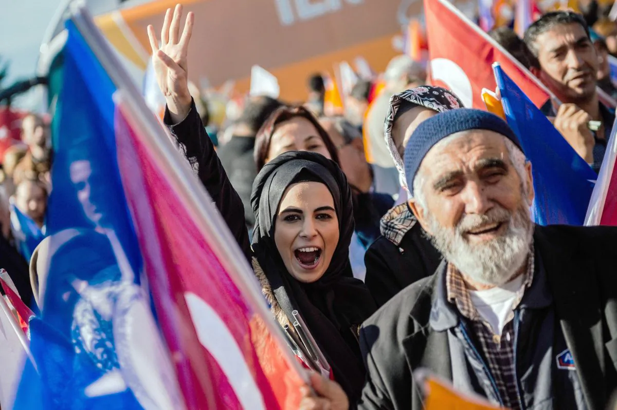 A Turkish woman makes a rabia sign as supporters wait for the Turkish Prime Minister Ahmet Davutoglu at the Istanbul Ataturk airport, on Nov. 3, 2015. Turkey's long dominant Justice and Development Party (AKP) scored a stunning election success at the weekend with a vote that returned it to single-party rule after months of political uncertainty. The result is likely to bolster strongman President Recep Tayyip Erdogan as he seeks to expand his powers, but analysts warn it could further exacerbate deep rifts in Turkish society. (Ozan Kose/AFP/Getty Images)