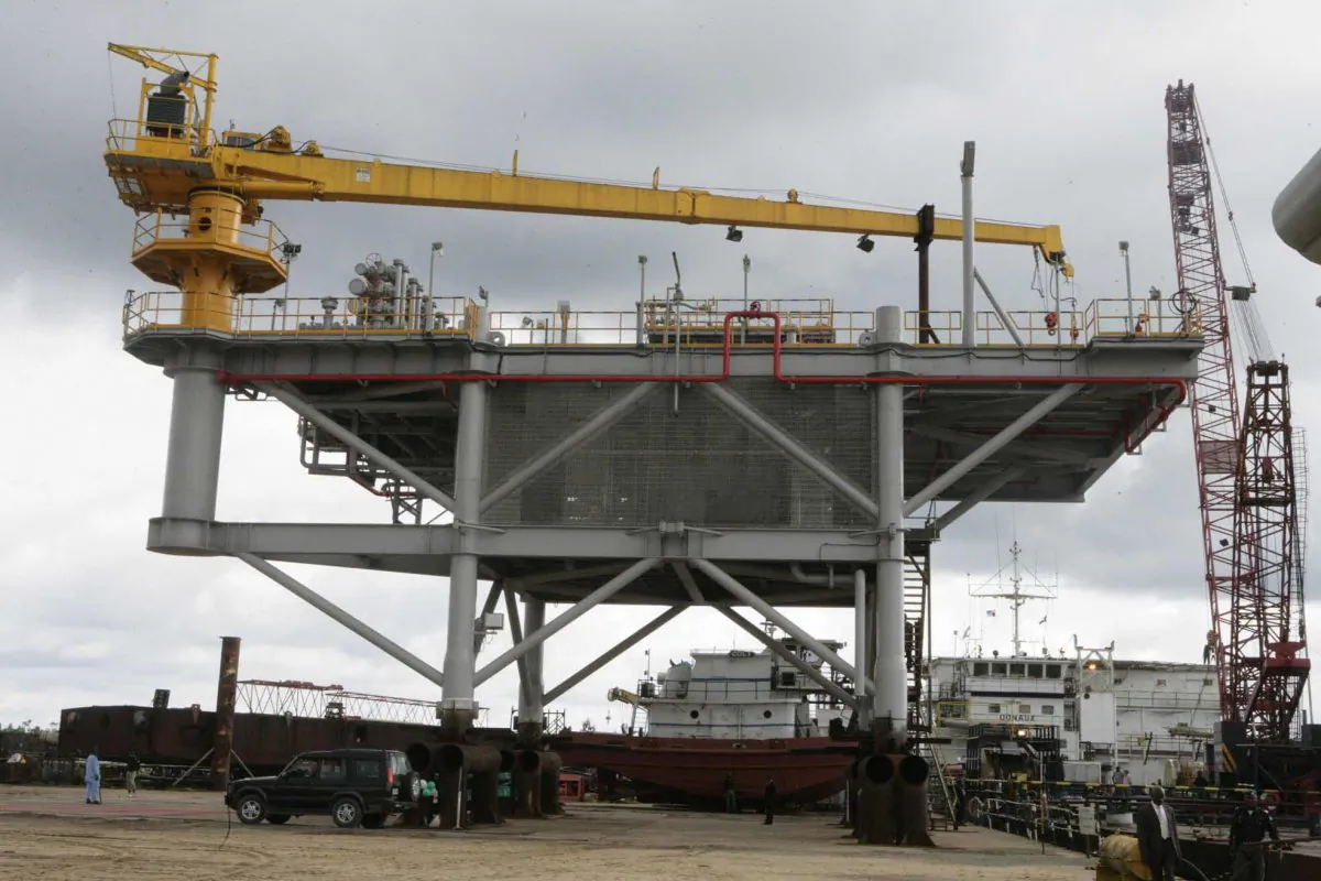 The Mejiriser platform located in Ogbogoro community, on the outskirt of Port Harcourt, appears on Oct. 12, 2006, as it was inaugurated by then Nigerian President Olusegun Obasanjo near the southern oil city of Port Harcourt. The nation's first floating flow station—built by the local firm Transcoastal Woas at a cost of $3.1 million—is a joint venture project between state-run Nigerian National Petroleum Corporation (NNPC) and Chevron. The four-legged platform, looking like a bridge, with 520 metric tons topside, has a production manifold and two hydro-carbon drain vessels. (Wole Emmanuel/AFP/Getty Images)