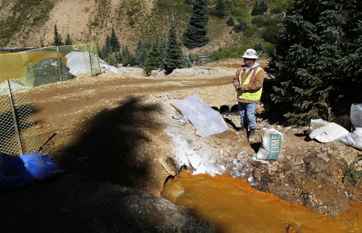 A U.S. Environmental Protection Agency (EPA) contractor keeps a bag of lime on hand to correct the PH of mine wastewater flowing into a series of sediment retention ponds, part of danger mitigation in the aftermath of the blowout at the site of the Gold King Mine outside Silverton, Colo., in 2015. (Brennan Linsley/AP Photo)