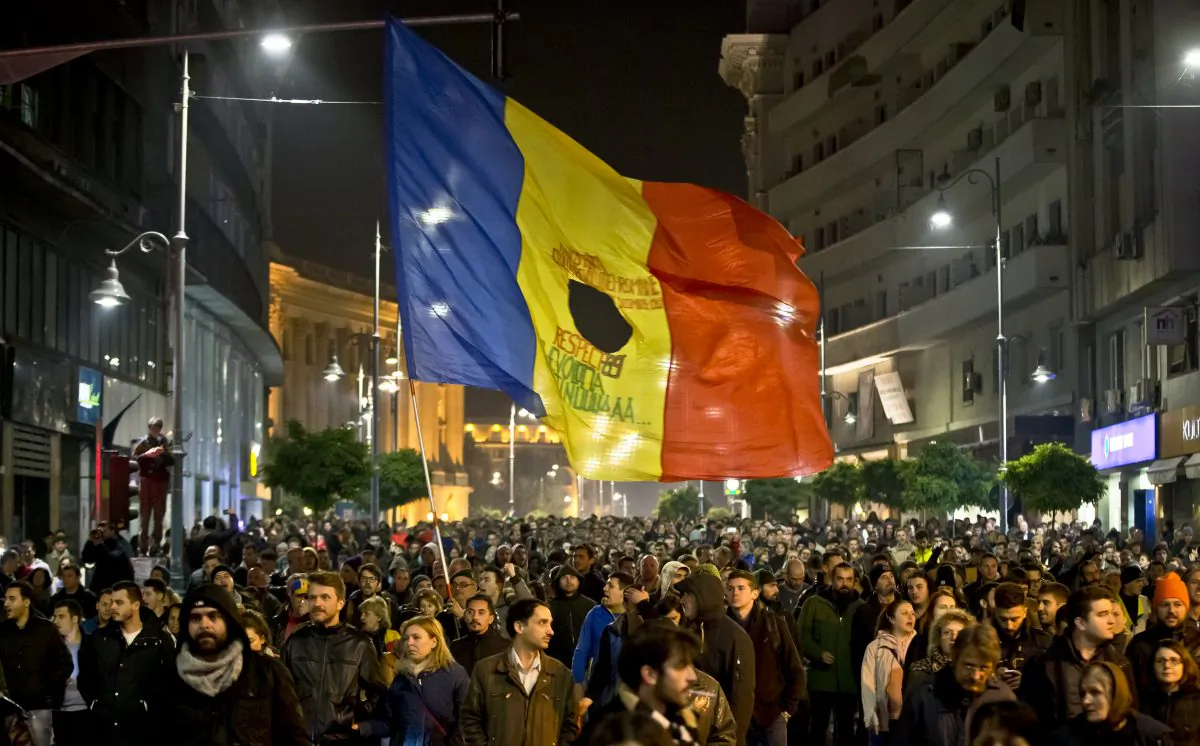 Romanians fill the Calea Victoriei, a main avenue of the Romanian capital, during a large protest in Bucharest, Romania, Tuesday, Nov. 3, 2015. (AP Photo/Vadim Ghirda)