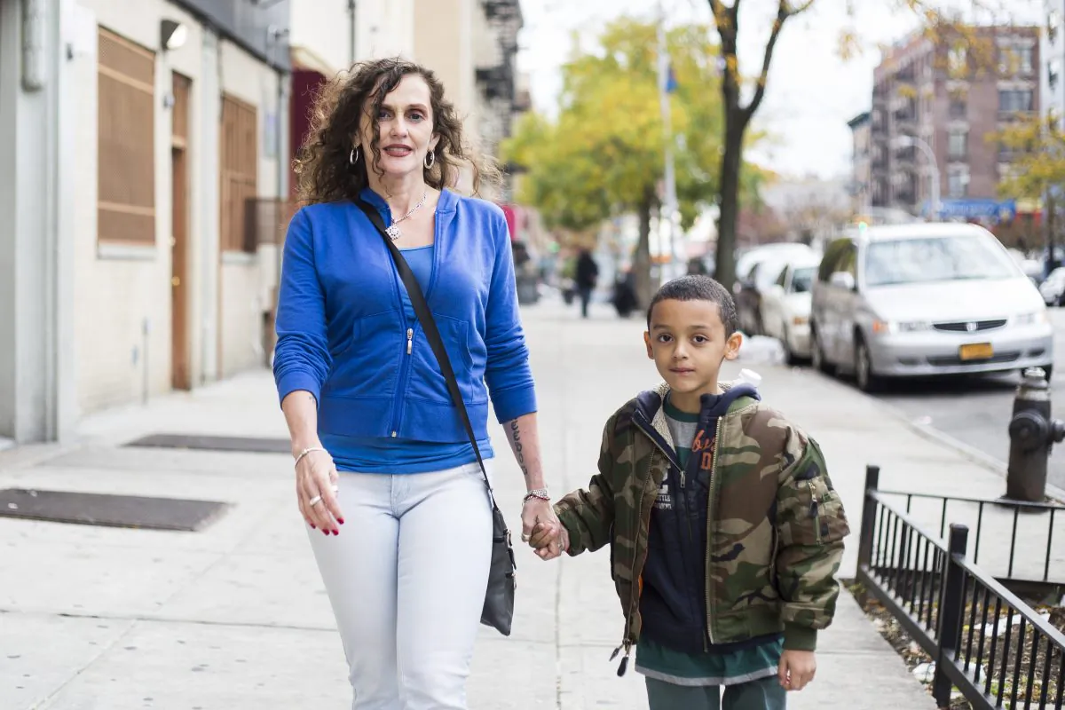 Lisa Ortega who has been drug-free since she completed her diversion program 25 years ago with her 7-year-old son Carlos Sabater in the Bronx, New York, on Nov. 1, 2015. (Samira Bouaou/Epoch Times)