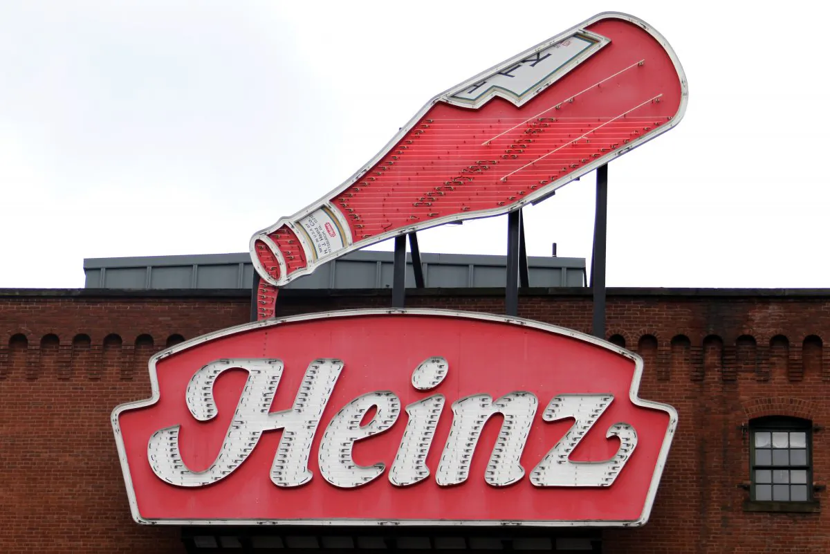 This is a neon Heinz ketchup sign on the side of the Senator John Heinz History Center in Pittsburgh March 25, 2015. H.J. Heinz Co. bought Kraft Foods Group Inc., creating what the companies say will be the third-largest food and beverage company in North America, the companies announced on March 25, 2015. (AP Photo/Gene J. Puskar)