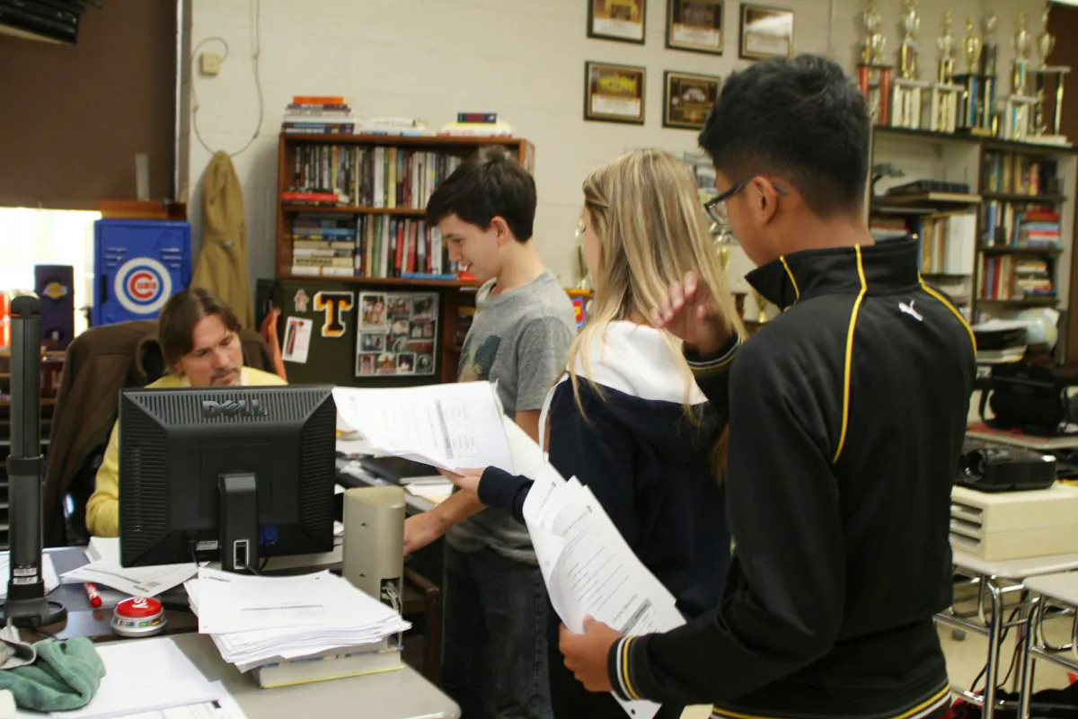 Eighth grade algebra students line up to speak to teacher Mark Olsen in his flipped classroom at Thomaston High School in Thomaston, Conn., on Oct. 9, 2015. The flipped teaching model does just that—flip the order in which students pursue their studies. Rather than hear lessons in class and do homework after school, students watch a lecture featuring new content at home, then work through exercises and projects during class. Thomaston eighth-graders are taught at Thomaston High School. (Laraine Weschler/Republican-American via AP)