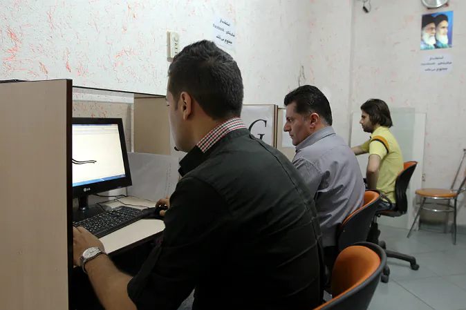 Iranians use internet at a cybercafe in the center of the Iranian capital Tehran on May 14, 2013.  (ATTA KENARE/AFP/Getty Images)