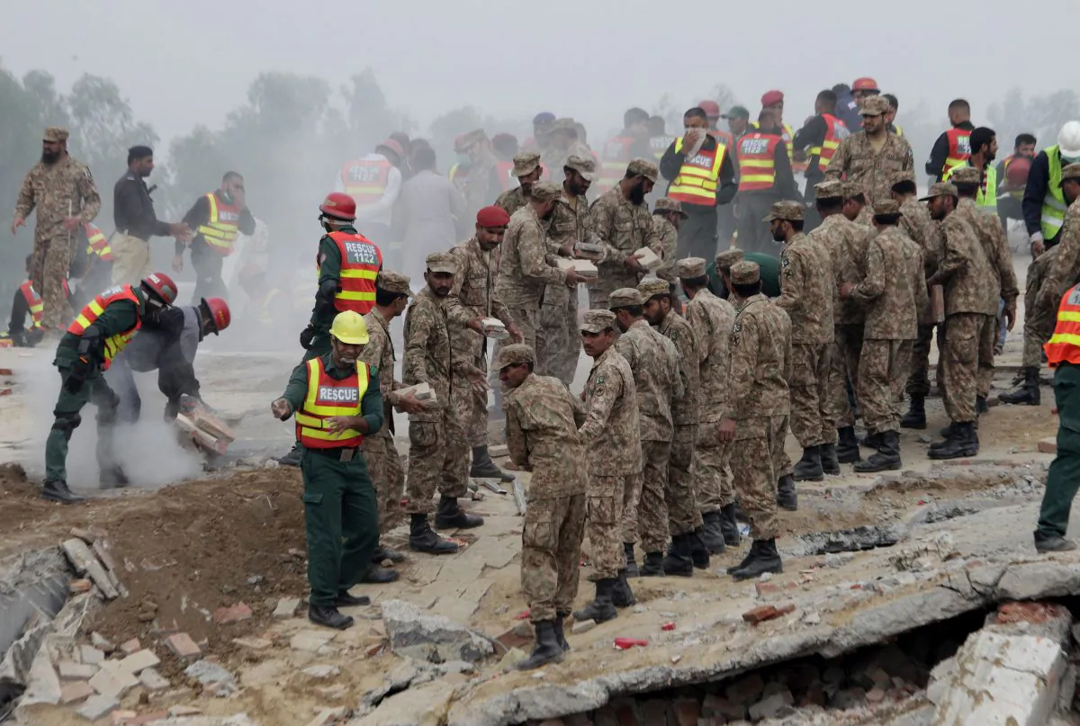 Pakistan army soldiers and volunteers take part in a rescue work in Lahore, Pakistan, Thursday, Nov. 5, 2015. (AP Photo/K.M. Chaudary)