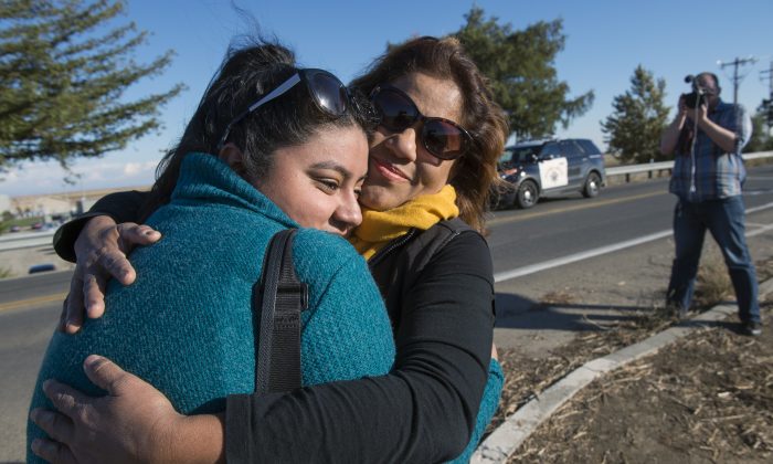 University of California, Merced studenKaren Bustamante, 18, hugs her mom Gloria Bustamante of San Leandro, Calif., after she left the UC Merced campus following a stabbing in Merced, Calif., Wednesday, Nov. 4, 2015. An assailant stabbed five people at the rural university campus in central California before police shot and killed him, authorities said Wednesday. (Paul Kitagaki Jr.(Paul Kitagaki Jr./The Sacramento Bee via AP)  MAGS OUT; LOCAL TELEVISION OUT (KCRA3, KXTV10, KOVR13, KUVS19, KMAZ31, KTXL40); MANDATORY CREDIT  (REV-SHARE) (ONLN OUT; IONLN OUT - MBI)