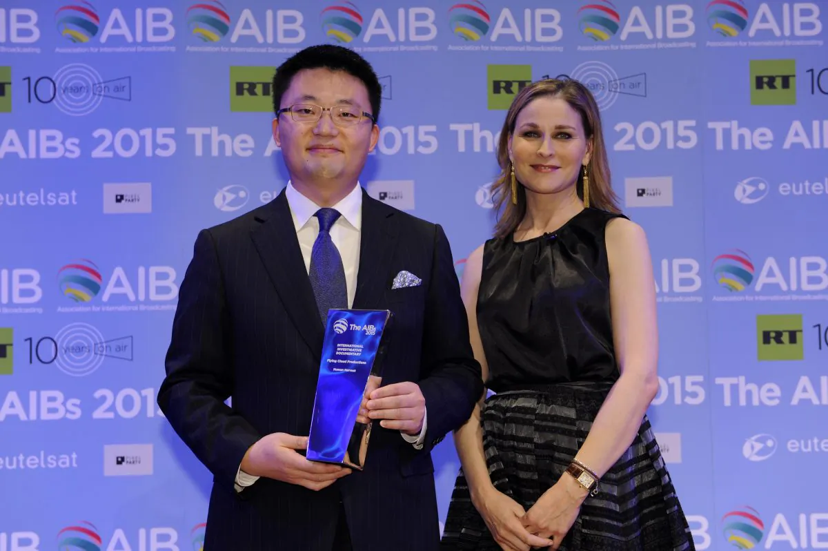 'Human Harvest' director Leon Lee receiving the AIB Award with CNN International’s anchor and correspondent Hala Gorani (Courtesy of AIB)