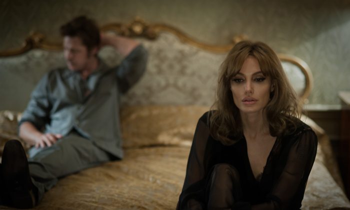 This photo provided by Universal Pictures shows, Brad Pitt, left, as Roland and Angelina Jolie Pitt as Vanessa in a scene from the film "By the Sea," directed by Jolie Pitt. The movie opens in U.S. theaters on Nov. 13, 2015. (Merrick Morton/Universal Pictures via AP)