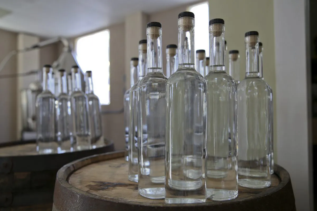 Bottles of white whiskey await their labels at the Franklin County Distilleries in Boones Mill, Va., on Oct. 22, 2015, the first legal distillery, since prohibition, in the town. (Stephanie Klein-Davis/The Roanoke Times via AP)