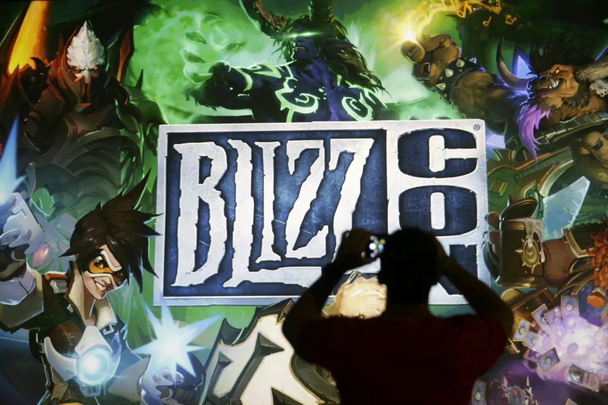A man takes pictures of the BlizzCon sign at the opening ceremony of the convention, Friday, Nov. 6, 2015, in Anaheim, Calif. (AP Photo/Jae C. Hong)