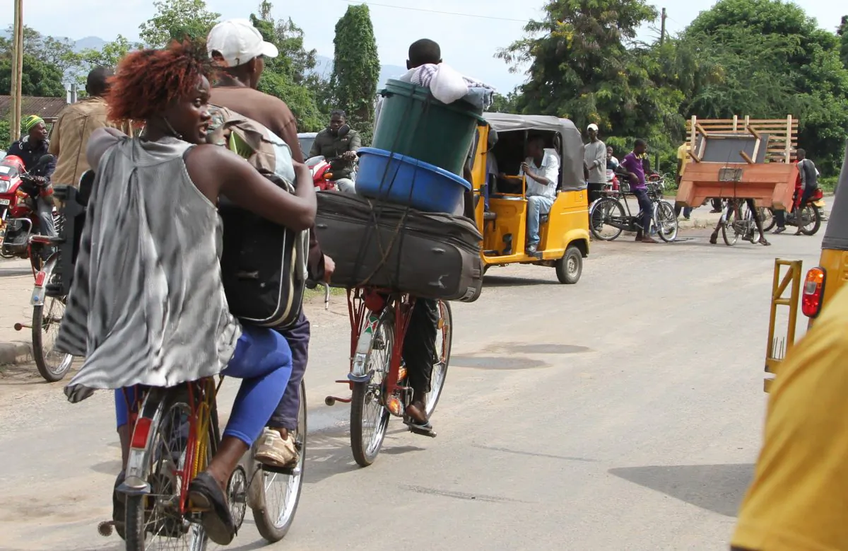 Burundians carry their belongings on bicycles in Bujumbura, Burundi, on Nov. 7, 2015. Holding their prized possessions, scores of people fled Burundi’s capital Saturday before a looming security crackdown that has left many predicting more bloody violence ahead. (AP Photo)
