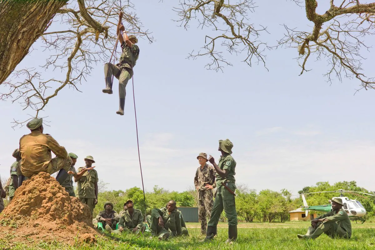 The elite rapid response team members perform rope training to ascend and descend from a helicopter at the Garamba National Park, Congo, on Dec. 29, 2014. A shootout last month, in which three rangers and a Congolese army colonel were killed, highlighted the challenge of protecting parks in a part of Africa plagued for decades by insurgencies, civil war, refugee flows and weak governments. It shows how some conservation efforts resemble a kind of guerrilla warfare in which rangers and soldiers stalk, and are stalked by, poachers who are slaughtering elephants and other wildlife. (Karen Lubbe/African Parks via AP)