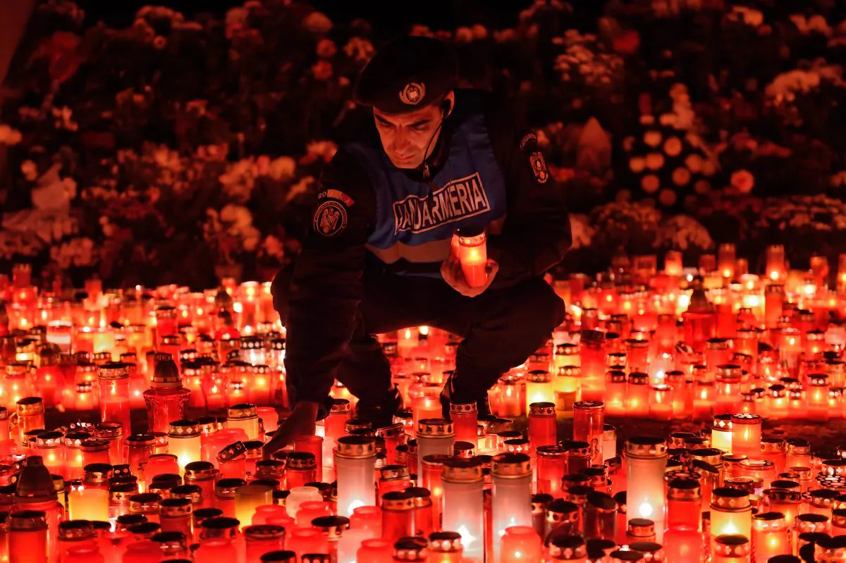 A Romanian gendarme places candles given by the people who came to pay respect for the victims of the fire at the Colectiv nightclub in Bucharest, Nov. 2, 2015. A fire and stampede at the club during the night to Oct. 31, 2015, left at least 39 people dead and nearly 200 injured. (Daniel Mihailescu/AFP/Getty Images)