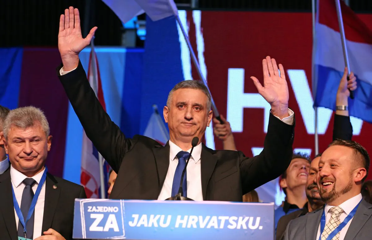 Leader of the conservative opposition Croatian Democratic Union party, Tomislav Karamarko (C), and supporters celebrate initial results of the general elections in Zagreb, on Nov. 8, 2015. Croatia's conservative opposition was leading the vote count late Nov. 8, 2015, after a general election dominated by concerns over the migrant crisis and a sluggish economy. (STR/AFP/Getty Images)