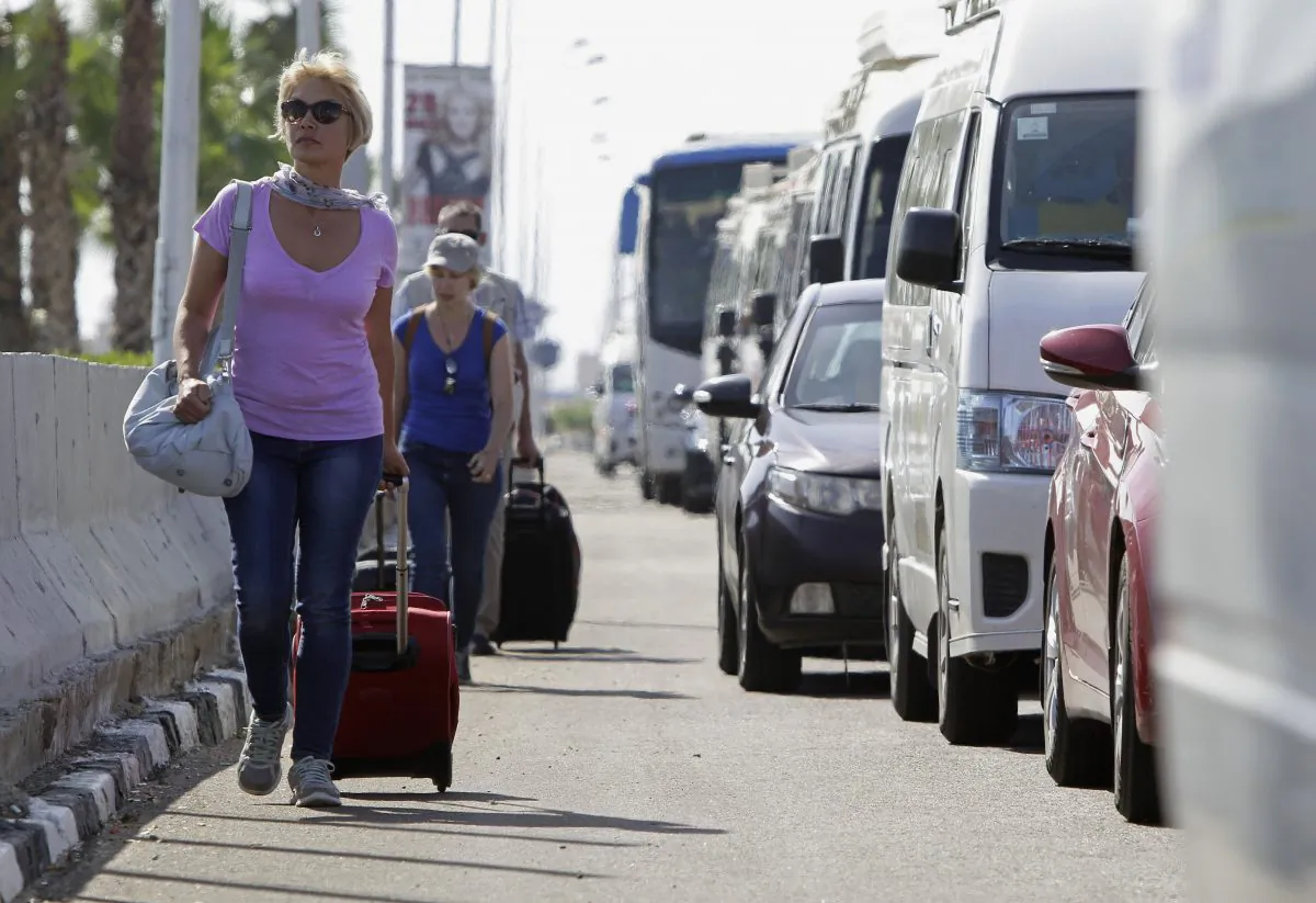 Tourists with their luggage walk towards the main entrance to the Sharm el-Sheikh airport in Egypt on Nov. 7, 2015. (AP Photo/Ahmed Abd al-Latif)