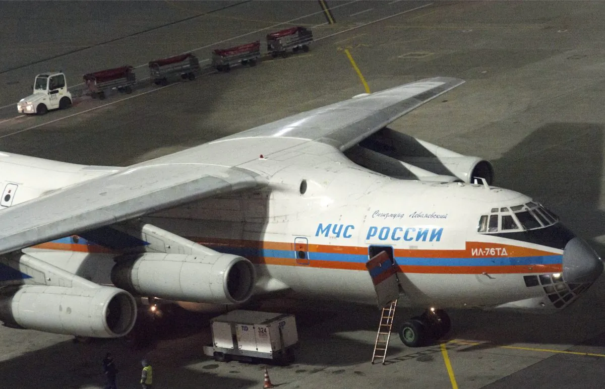 Vnukovo airport employees unload luggage from an Emergency Ministry plane at Vnukovo airport outside Moscow, Sunday, Nov. 8, 2015. The plane delivered luggage of tourists from the Egyptian resort of Sharm-El-Sheikh. Around 3 tons of luggage of tourists who departed with 5 flights before were reloaded by emergency ministry staff. (AP Photo/Denis Tyrin)