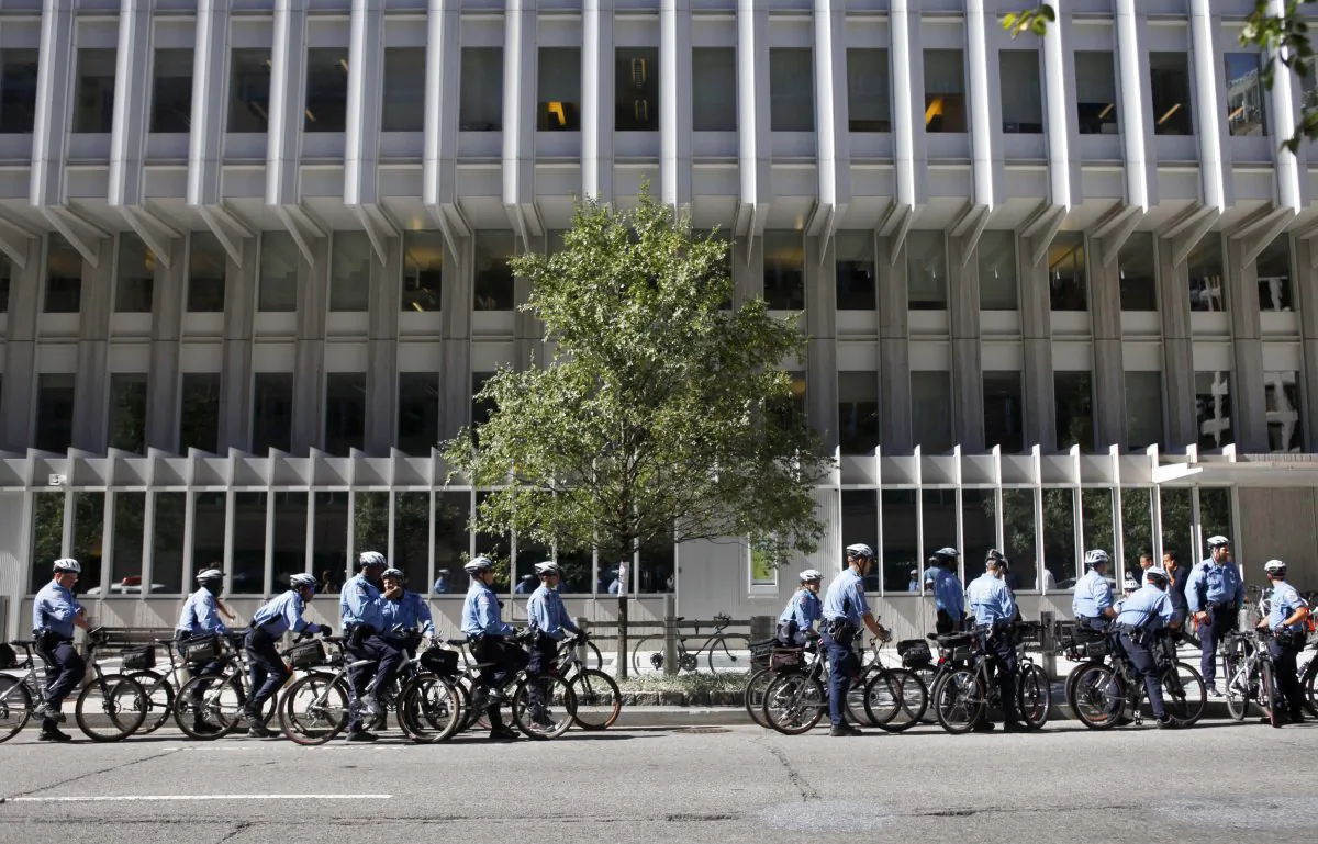 Bicycle police officers line the street outside the World Bank offices in Washington, D.C., during the annual meeting of the World Bank and International Monetary Fund, on Oct. 8, 2010. Climate change could push more than 100 million people into extreme poverty by 2030 by disrupting agriculture and fueling the spread of malaria and other diseases, the World Bank said in a report Sunday Nov. 8, 2015. (AP Photo/Jacquelyn Martin)