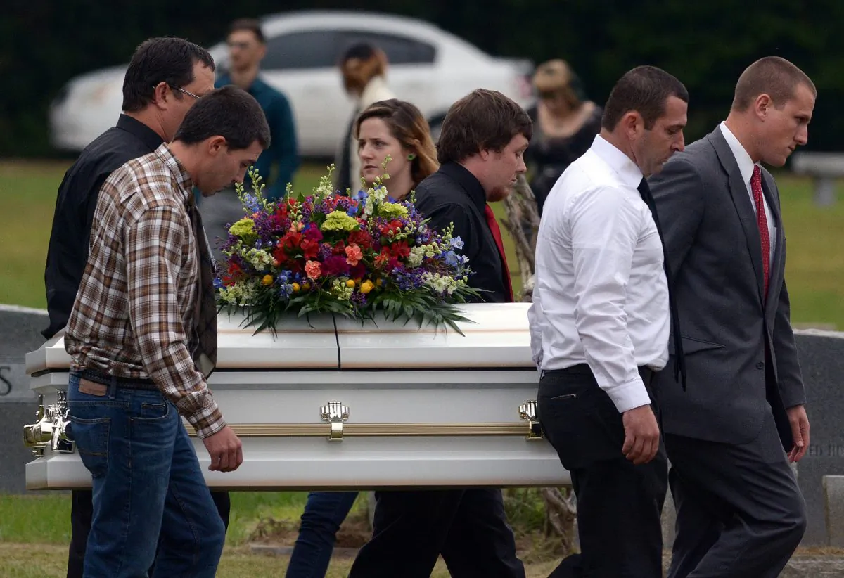 Pallbearers carry the casket of 6-year-old Jeremy Mardis to the grave site at Beaumont Cemetery in Beaumont, Miss., 30 miles east of Hattiesburg, Monday, Nov. 9, 2015. Jeremy Mardis, a 6-year-old autistic boy, was killed and his father wounded when marshals opened fire on their vehicle in Marksville, La., on Nov. 3. Louisiana State Police announced late Friday that they had arrested the two marshals in the shooting. (Eli BaylisHattiesburg American via AP)