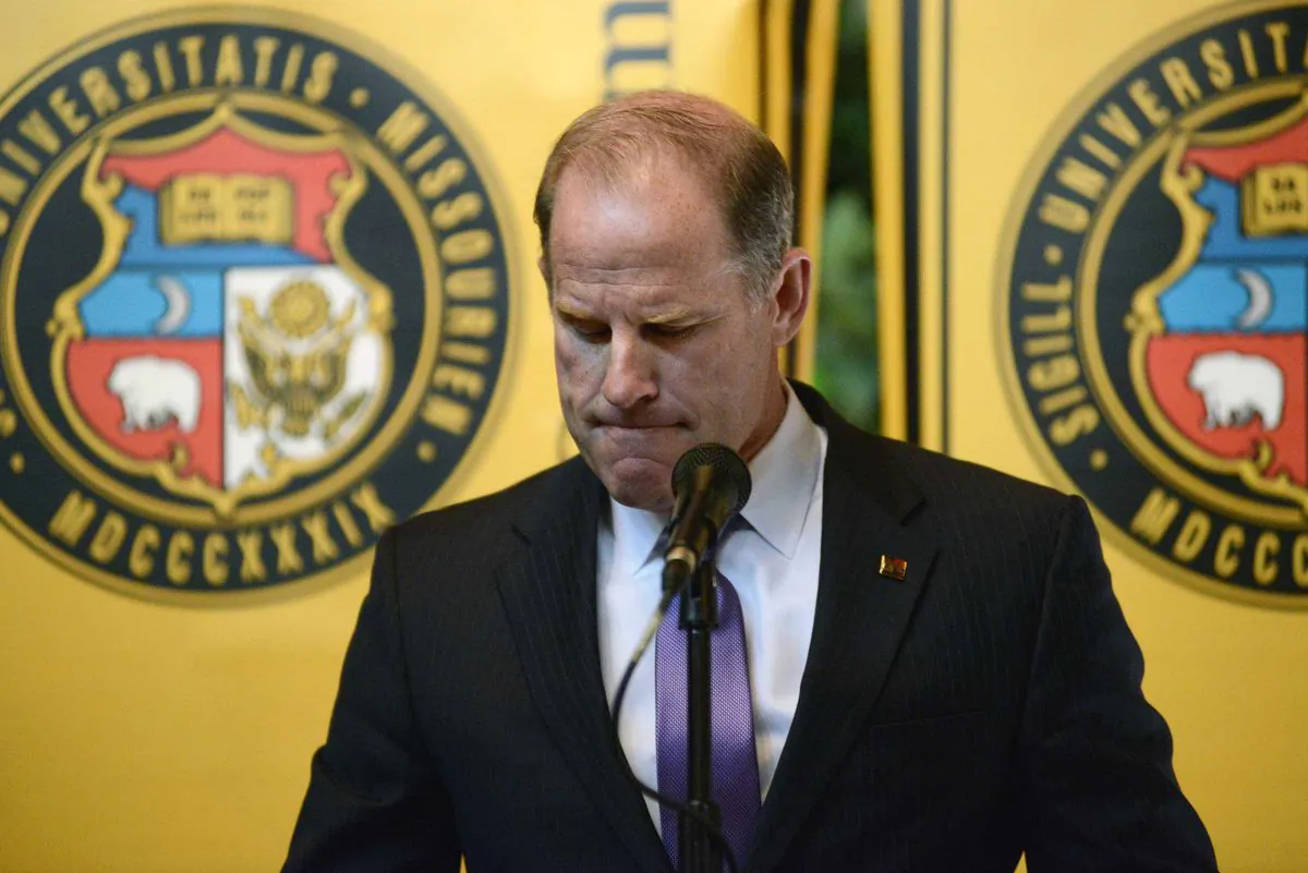 University of Missouri system President Tim Wolfe announces his resignation from office, Monday, Nov. 9, 2015, during a UM System Board of Curators meeting in University Hall at the campus in Columbia, Mo. Wolfe has been under fire for his handling of race complaints that had threatened to upend the football season and moved one student to go on a hunger strike. (Justin L. Stewart/Columbia Missourian via AP)