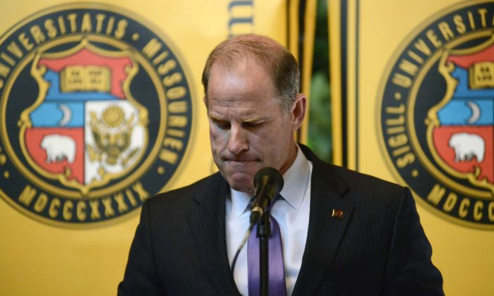 University of Missouri system President Tim Wolfe announces his resignation from office, Monday, Nov. 9, 2015, during a UM System Board of Curators meeting in University Hall at the campus in Columbia, Mo. Wolfe has been under fire for his handling of race complaints that had threatened to upend the football season and moved one student to go on a hunger strike. (Justin L. Stewart/Columbia Missourian via AP)