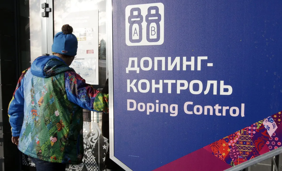 A man walks past a sign reading doping control, at the Laura biathlon and cross-country ski center, at the 2014 Winter Olympics in Krasnaya Polyana, Russia, on Feb. 21, 2014. (AP Photo/Lee Jin-man)