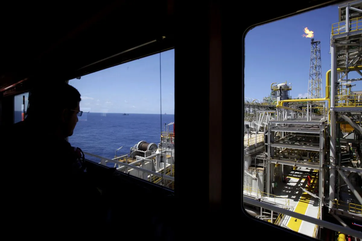 An oil worker looks out, over the Petrobras offshore ship platform over Tupi field in Santos Bay off the coast of Rio de Janeiro, Brazil, on Oct. 28, 2010. (AP Photo/Felipe Dana)