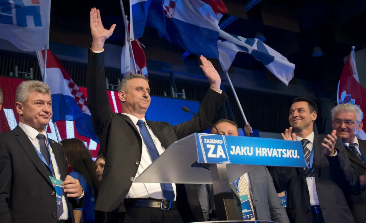 Opposition leader Tomislav Karamarko (2L) celebrates his coalition's winning of majority of votes, in Zagreb, Croatia, early Monday, Nov. 9, 2015. (AP Photo/Darko Bandic)