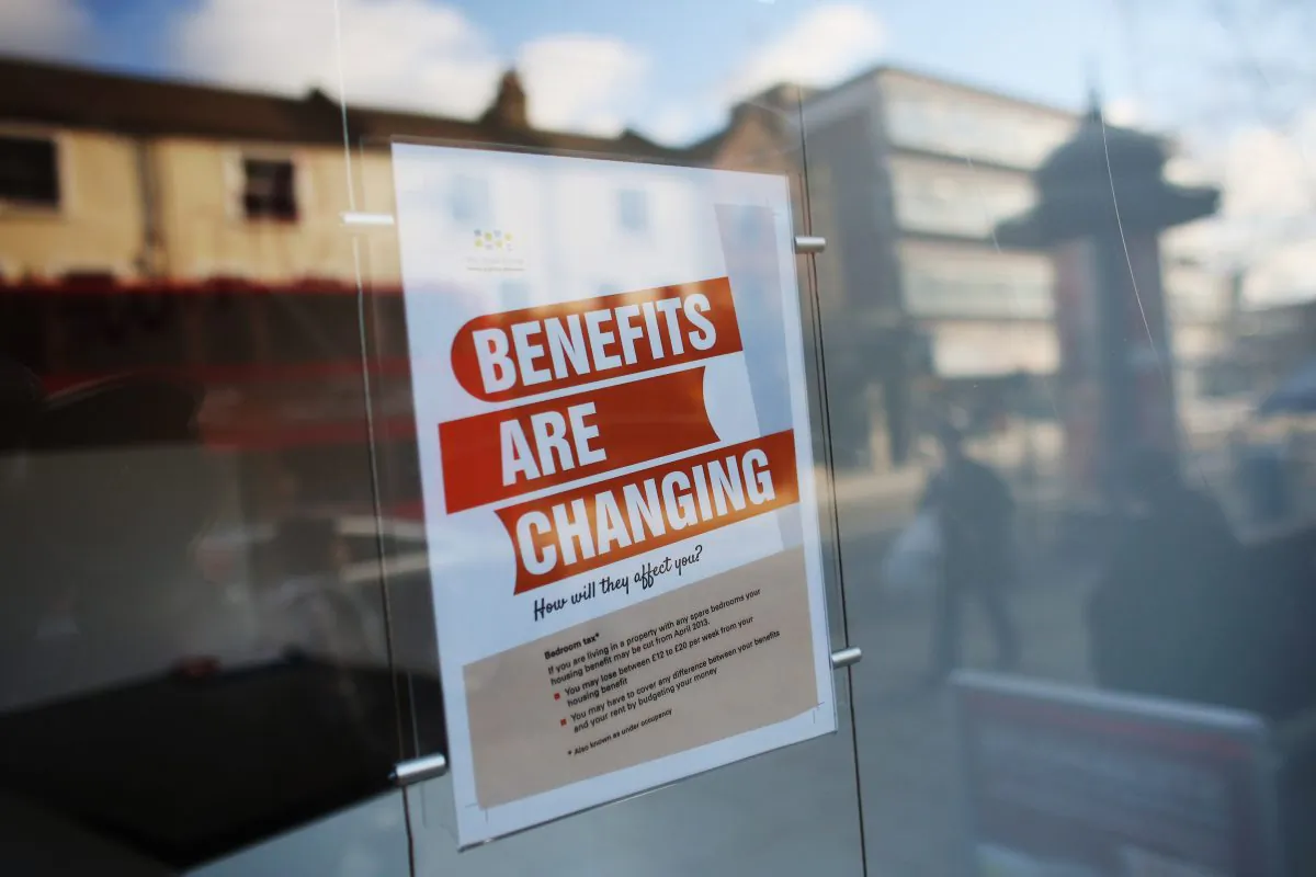 A sign informs members of the public on changes to benefits on Lewisham high street, in London, England, on on Dec. 5, 2012. (Oli Scarff/Getty Images)