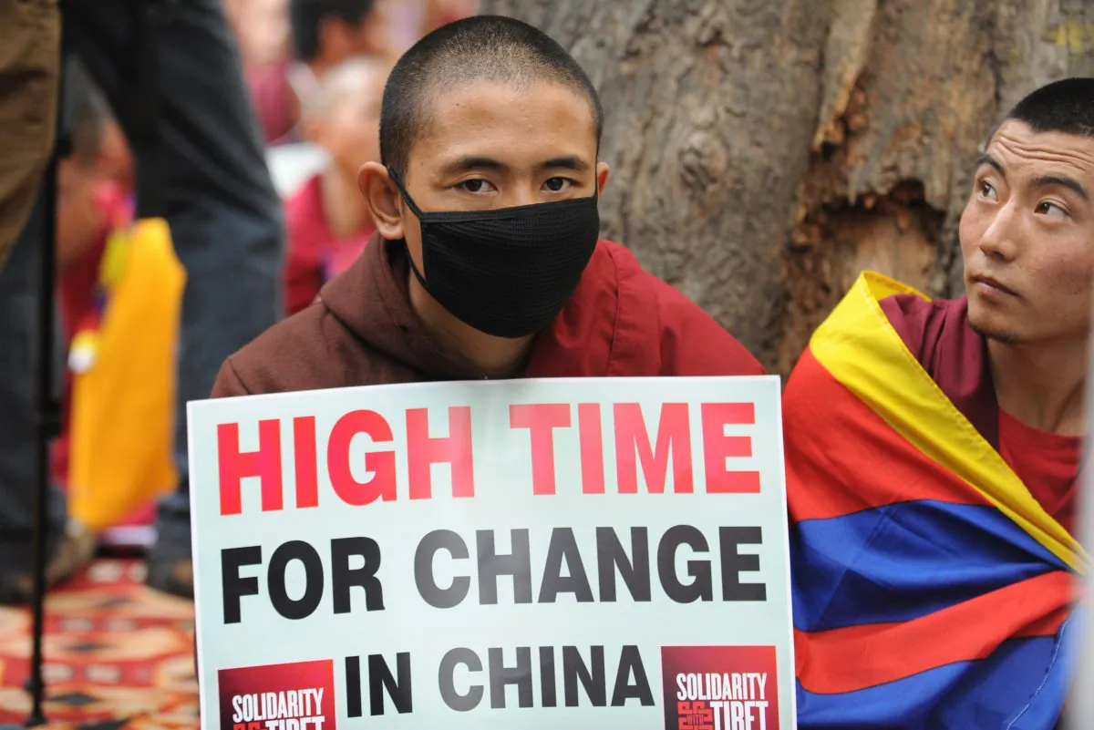 Tibetans monks hold placards during a protest rally in New Delhi on January 31, 2013. The Chinese regime has deployed a new surveillance system, which will make it more difficult for Tibetans to escape to Nepal. (Raveendran/AFP/Getty Images)