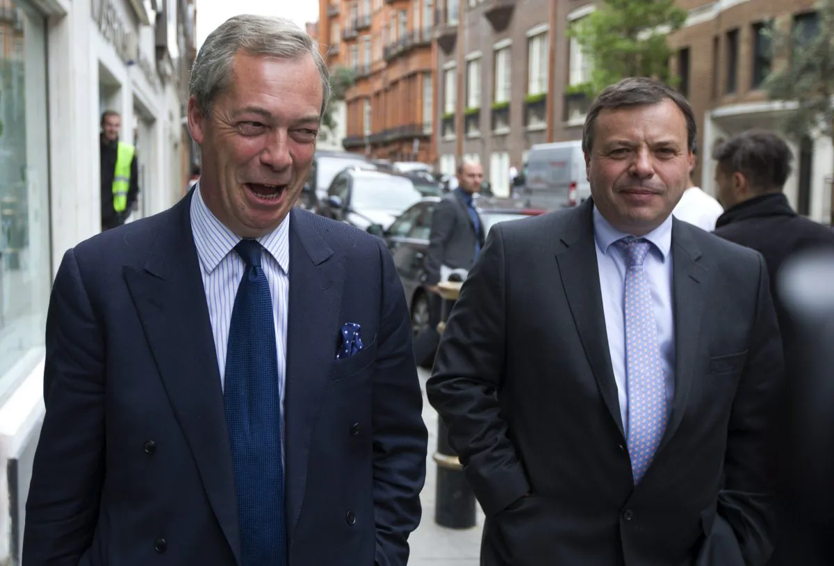 U.K. Independence Party (UKIP) leader Nigel Farage (L) and major donor Arron Banks leave the party's head office in central London on May 15, 2015. (Justin Tallis/AFP/Getty Images)