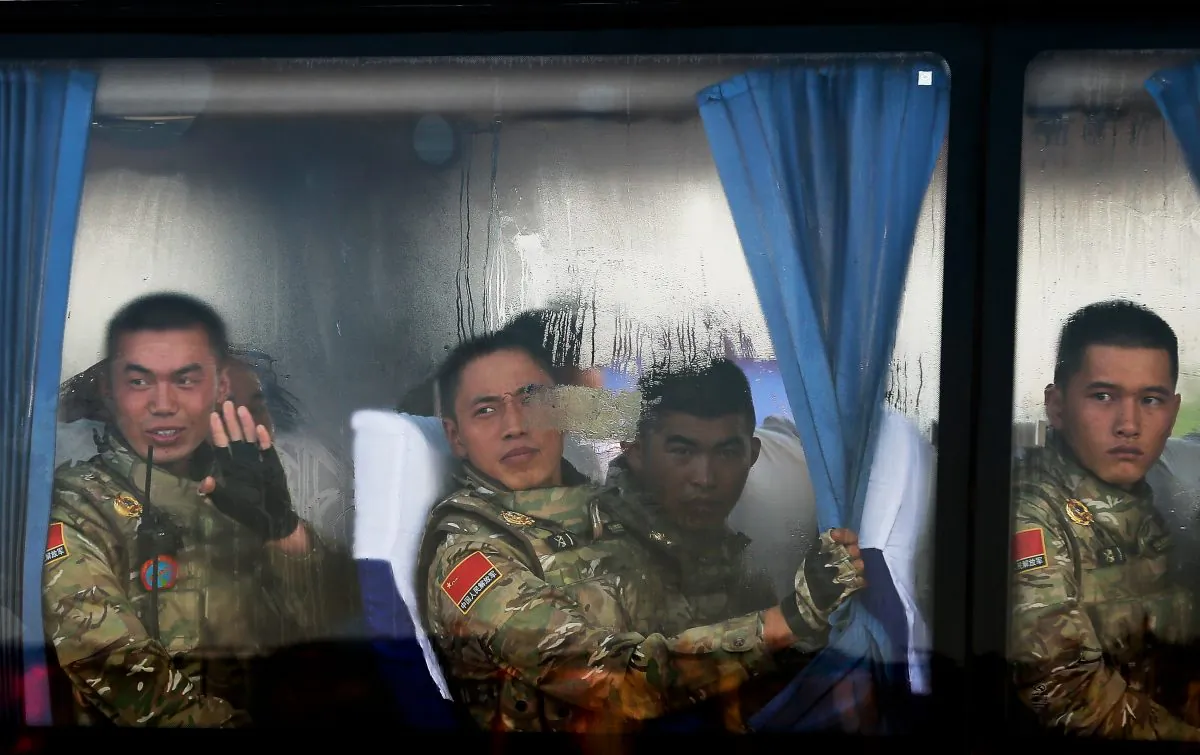 Chinese People's Liberation Army troops look out from a bus as they arrive at Tiananmen Gate in Beijing on Sept. 3. The Chinese regime is planning to restructure its military, and control of its hacker units may be shifted. (Andy Wong/Getty Images)