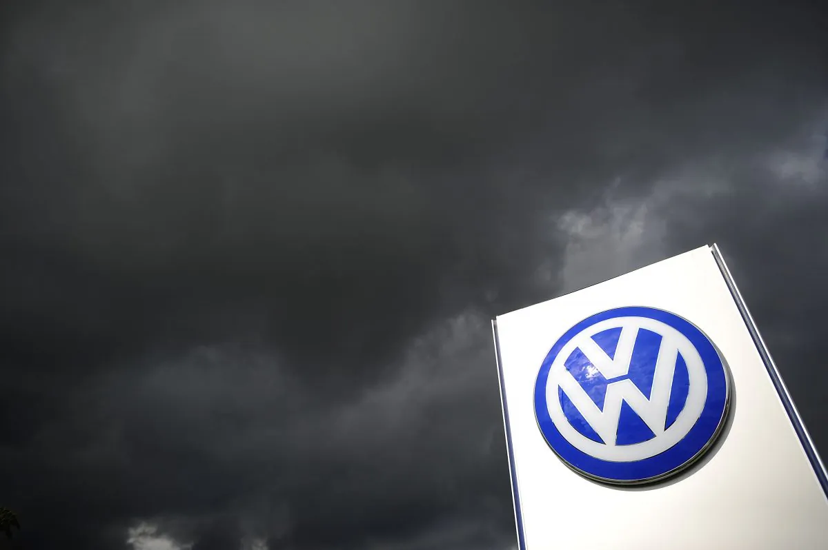 Rain clouds are seen over a Volkswagen symbol at the main entrance gate at Volkswagen production plant in Wolfsburg, Germany, on on Sept. 23, 2015. (Alexander Koerner/Getty Images)