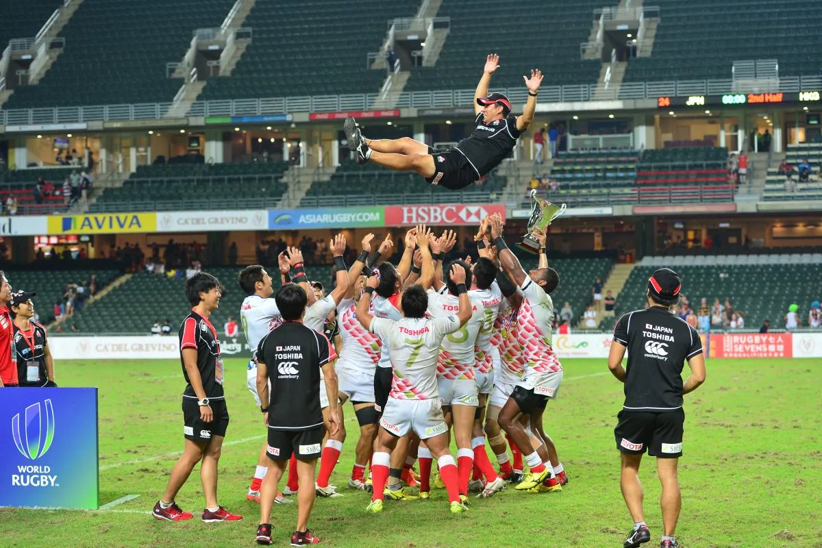 The Japan Rugby Sevens team tosses their coach Tomohiro Segawa into the air in celebration of qualifying for the 2016 Rio Olympics after winning the Asia Rugby Sevens Qualifying competition in Hong Kong on the weekend of Nov 7 – 8, 2015. (Bill Cox/Epoch Times)