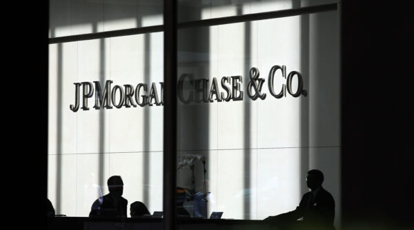 People pass a sign for JPMorgan Chase & Co. at its headquarters in Manhattan in New York City on Oct. 2, 2012. (Spencer Platt/Getty Images)