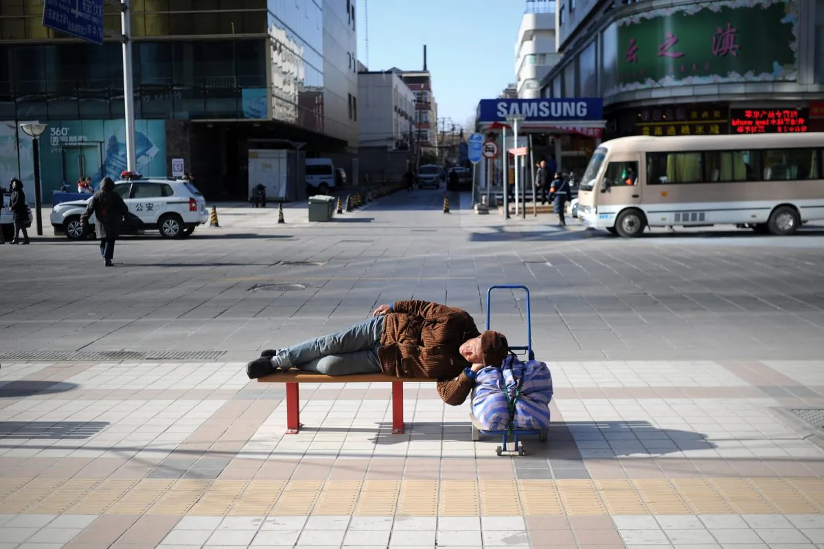 An elderly man rests on a bench in Beijing on Jan. 3, 2014. (Wang Zhao/AFP/Getty Images)