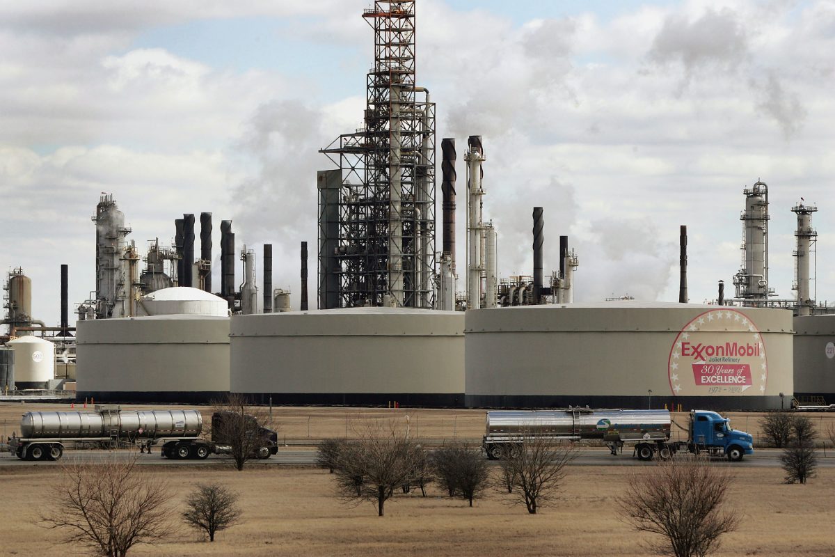 Tanker trucks drive past an ExxonMobil oil refinery in Joliet, Ill. on March 8, 2005. (Scott Olson/Getty Images)