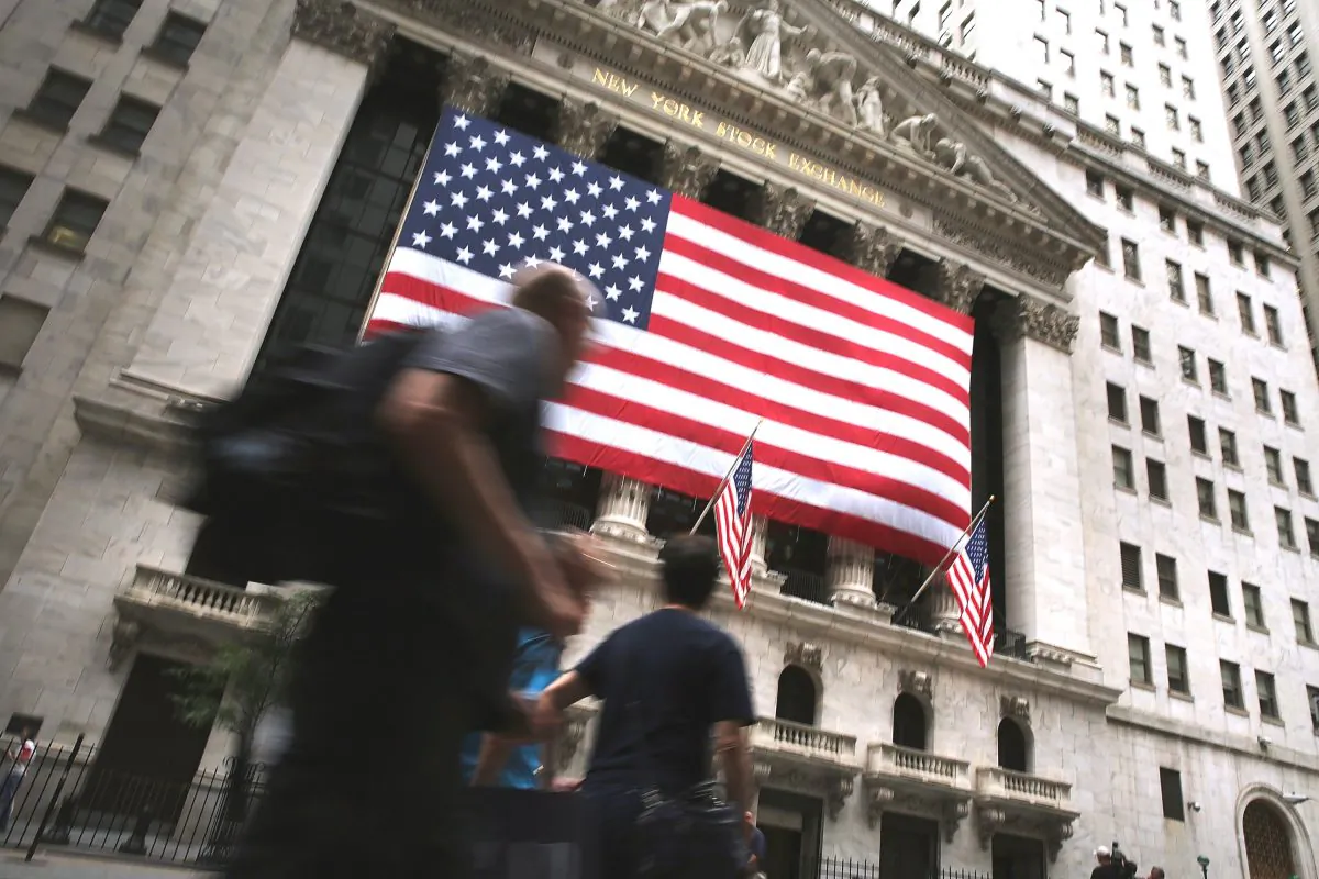 People walk outside past the New York Stock Exchange (NYSE) building at the close of the day after trading was paused for nearly four hours due to a "technical glitch" on July 8, 2015 in New York City. (Spencer Platt/Getty Images)