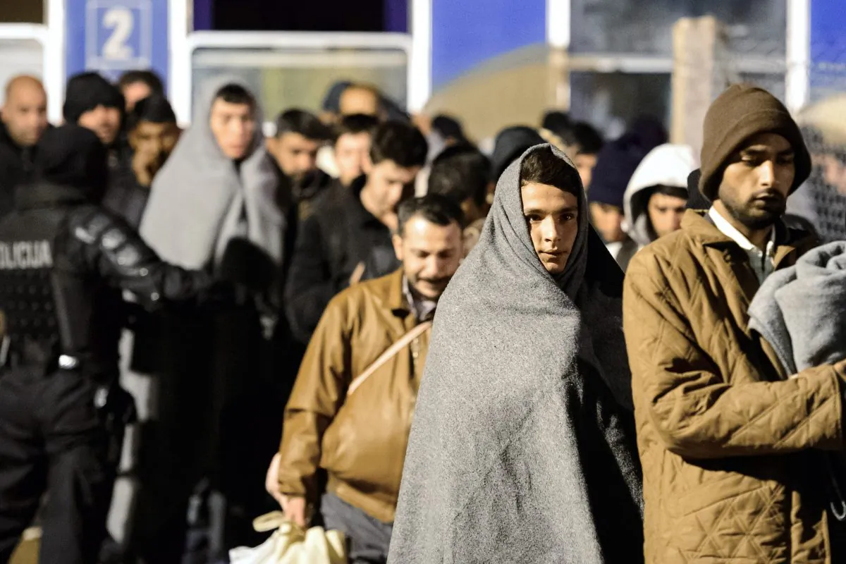 A man wears a blanket as migrants and refugees walk towards a refugee center in Sentilj, after arriving by train on November 4, 2015. (Jure Makovec/AFP/Getty Images)